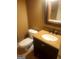 Cozy half-bathroom with a dark vanity, granite countertops, and toilet at 245 Ashley Forest Dr, Fayetteville, GA 30214