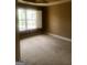 Bedroom featuring neutral colored walls, carpet flooring, and bright window at 245 Ashley Forest Dr, Fayetteville, GA 30214