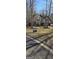 Charming two-story home with beautiful landscaping in a serene, wooded setting and a 'For Sale' sign displayed at 245 Ashley Forest Dr, Fayetteville, GA 30214