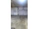 Spacious two-car garage with concrete floors and white garage doors at 245 Ashley Forest Dr, Fayetteville, GA 30214
