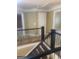 View of the hallway with decorative wrought iron railing and doorways to other rooms at 245 Ashley Forest Dr, Fayetteville, GA 30214