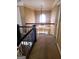 Second story hallway with decorative wrought iron railing and view of hanging chandelier at 245 Ashley Forest Dr, Fayetteville, GA 30214