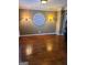 Inviting living room with hardwood floors, decorative wall art, and sconce lighting at 245 Ashley Forest Dr, Fayetteville, GA 30214