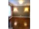Bright living room featuring hardwood floors, sconce lighting, and lots of light from the window at 245 Ashley Forest Dr, Fayetteville, GA 30214