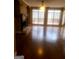 Spacious living room with hardwood floors, fireplace, and a wall of windows at 245 Ashley Forest Dr, Fayetteville, GA 30214