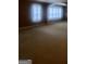 Spacious bedroom with neutral carpeting, two windows with shutters, and decorative wall sconces at 245 Ashley Forest Dr, Fayetteville, GA 30214