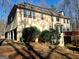 Rear view of a home with a deck, a walkout basement, and a two-car garage at 245 Ashley Forest Dr, Fayetteville, GA 30214