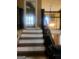 Staircase with wrought iron railing and hardwood floors leads to the upper level at 245 Ashley Forest Dr, Fayetteville, GA 30214