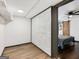 View of basement flex space with white brick accent wall and bedroom with sliding barn door at 3044 Sunset Ln, East Point, GA 30344