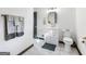 Renovated bathroom featuring a white vanity, square mirror, and classic tile floors at 3044 Sunset Ln, East Point, GA 30344