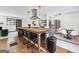 Open kitchen with a large island, stainless steel appliances, and modern lighting at 3044 Sunset Ln, East Point, GA 30344