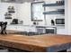 Kitchen featuring a large butcher block island, stainless steel appliances, and open shelving at 3044 Sunset Ln, East Point, GA 30344