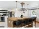 Modern kitchen island featuring a wooden countertop with bar stool seating and stylish pendant lights at 3044 Sunset Ln, East Point, GA 30344