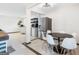 Open dining area and kitchen featuring stainless steel appliances, tile floor and dining table at 3044 Sunset Ln, East Point, GA 30344