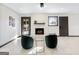 Bright living room with a white brick fireplace, modern seating, and tile floors at 3044 Sunset Ln, East Point, GA 30344