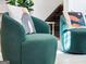 Cozy corner with plush green chairs and contemporary decor near the staircase at 3044 Sunset Ln, East Point, GA 30344