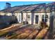 Backyard patio area featuring a fence, shrubs, and access doors to the home at 181 Linton Dr, Acworth, GA 30102