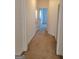Carpeted hallway with white walls and trim leads to various rooms within the home at 181 Linton Dr, Acworth, GA 30102
