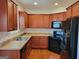Well-lit kitchen boasting wood cabinets, modern black appliances, and a stainless steel sink at 181 Linton Dr, Acworth, GA 30102