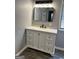 Bathroom with a modern vanity, featuring a stone countertop, white cabinets, and a sleek black faucet at 23 Hampton Locust Grove Rd, Hampton, GA 30228