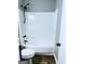Clean bathroom featuring a shower-tub combination, updated fixtures, and modern design elements at 23 Hampton Locust Grove Rd, Hampton, GA 30228