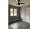 Cozy bedroom featuring a ceiling fan, hardwood floors, and ample natural light from the window at 23 Hampton Locust Grove Rd, Hampton, GA 30228