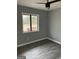 Cozy bedroom showcasing hardwood floors and a window overlooking a private outdoor space at 23 Hampton Locust Grove Rd, Hampton, GA 30228