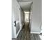 Bright hallway with hardwood floors and white doors leading to various rooms of the home at 23 Hampton Locust Grove Rd, Hampton, GA 30228