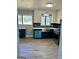 A modern kitchen features white cabinets, stainless steel appliances, blue accents, and new countertops at 23 Hampton Locust Grove Rd, Hampton, GA 30228