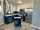 Modern kitchen with blue cabinets, white upper cabinets, stainless steel appliances, and hardwood flooring at 23 Hampton Locust Grove Rd, Hampton, GA 30228