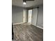 Open living room features wood-look flooring and a barn door, blending rustic charm with modern style at 23 Hampton Locust Grove Rd, Hampton, GA 30228