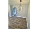 A spacious living room featuring wood floors, an arched doorway, gray walls, and a decorative light at 23 Hampton Locust Grove Rd, Hampton, GA 30228