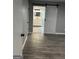 Bedroom with wood floor and the bathroom with vanity is through the sliding barn door at 23 Hampton Locust Grove Rd, Hampton, GA 30228