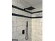 The shower features elegant white tile, a rainfall shower head, and a sleek handheld sprayer at 23 Hampton Locust Grove Rd, Hampton, GA 30228