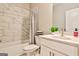 Bright bathroom featuring marble tiled walls, shower-tub combo, and white vanity at 429 Stagecoach Bnd, Smyrna, GA 30080