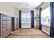 Bright bedroom featuring dark wood floors, a dresser, and large windows with curtains at 429 Stagecoach Bnd, Smyrna, GA 30080