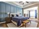Spacious bedroom with a striking blue accent wall, bench, and wooden nightstands at 429 Stagecoach Bnd, Smyrna, GA 30080