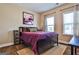 Bedroom features a purple bed, a window and light streaming through with wooden floors at 429 Stagecoach Bnd, Smyrna, GA 30080