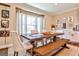 Inviting dining room with large window, rustic table, bench seating, and decorative wall art at 429 Stagecoach Bnd, Smyrna, GA 30080