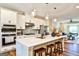Modern kitchen features stainless appliances, sleek white cabinets, and center island with barstool seating at 429 Stagecoach Bnd, Smyrna, GA 30080
