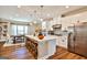 Bright kitchen features white cabinets, stainless steel appliances, and an island with seating at 429 Stagecoach Bnd, Smyrna, GA 30080