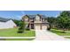 Charming two-story brick home featuring a well-manicured lawn and a two-car garage, perfect for Gathering living at 207 Birchwood Dr, Loganville, GA 30052