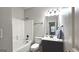 Bathroom with a shower and tub combo, single vanity, and neutral wall color at 207 Birchwood Dr, Loganville, GA 30052
