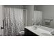 Bathroom featuring a shower and tub combo, double vanity, and white floral shower curtain at 207 Birchwood Dr, Loganville, GA 30052