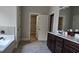 Bathroom featuring a tub, shower, toilet, double sink, and large walk-in closet at 207 Birchwood Dr, Loganville, GA 30052