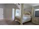 Bedroom with carpet, a ceiling fan and an elaborate four-poster bed at 207 Birchwood Dr, Loganville, GA 30052