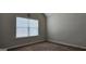 Bedroom with neutral carpet, window with blinds and neutral wall color at 207 Birchwood Dr, Loganville, GA 30052