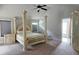 Bedroom with carpet, a ceiling fan and an elaborate four-poster bed at 207 Birchwood Dr, Loganville, GA 30052