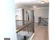 Upstairs hallway featuring decorative iron railings and views to the other rooms at 207 Birchwood Dr, Loganville, GA 30052