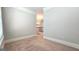 A spacious hallway with neutral carpeting and trim leads to additional rooms in the home at 207 Birchwood Dr, Loganville, GA 30052
